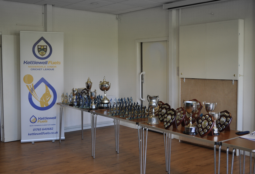 Kettlewell Fuels A table at the Nidderdale Junior Cricket League Presentation 2023 showing the trophies and shields.